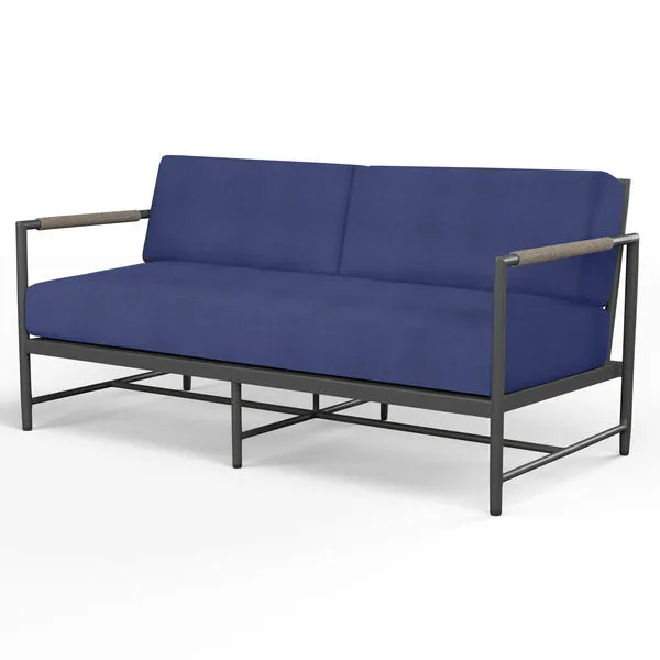 Pietra Loveseat with matte graphite aluminum frame and deep blue cushions featuring rounded tube arms with shale rope accents