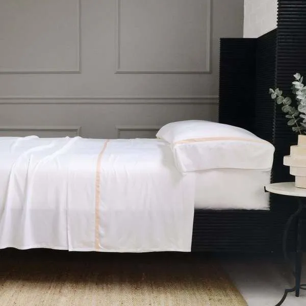 Warm sand colored Langston Bamboo Sateen Pillowcase set of 2 on standard pillows with smooth, soft sateen finish