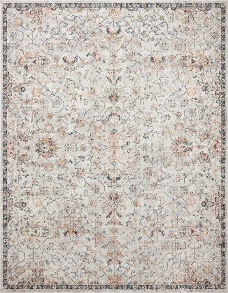 Traditional style navy rug with faded floral patterns and soft, muted color palette