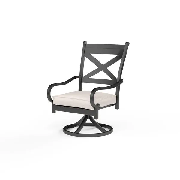 Monterey Swivel Dining Chair with dark metal frame, crisscross backrest, curved armrests, and light beige seat cushion