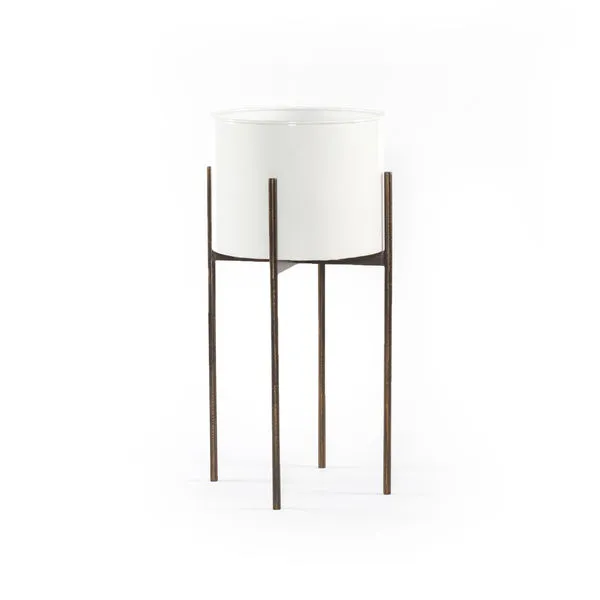 Tall outdoor planter with a smooth white cylindrical pot on a slender, textured dark metal stand