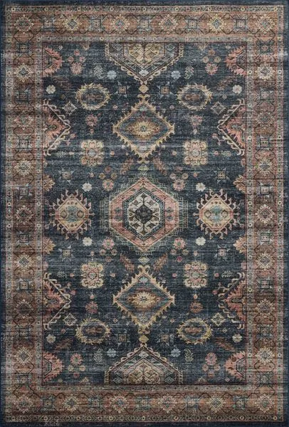 Traditional-style area rug with geometric motifs in distressed navy blue, peach, beige, and light blue tones