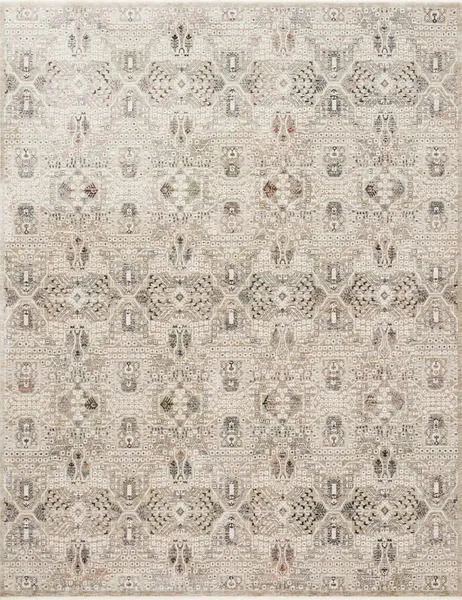 Theia Granite / Ivory Rug with neutral geometric and floral motifs, subtle pile height variation, and a refined fringe border