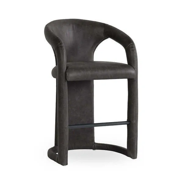 Counter stool with distressed dark leather upholstery, curved backrest, integrated armrests, and black metal footrest