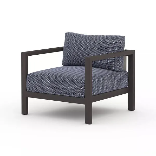 Sonoma Outdoor Chair in bronze frame with blue textured cushions and modern angular design
