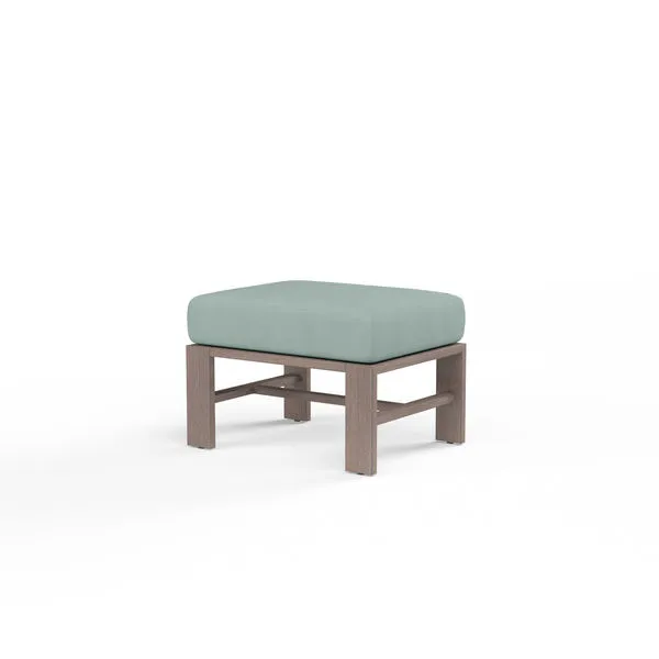 Laguna Ottoman with hand-brushed aluminum frame mimicking driftwood and light blue cushioned top