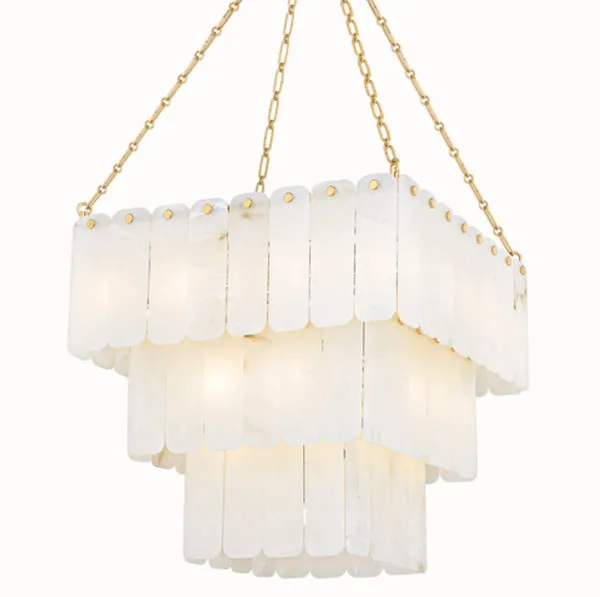 Chandelier glowing warmly when lit, emphasizing alabaster translucency and soft ambient light
