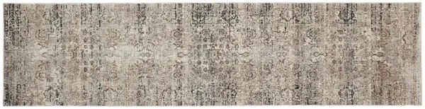 Long rectangular beige and rust vintage style rug with intricate ornamental motifs and hints of inky blue
