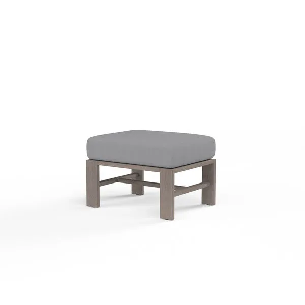 Laguna Ottoman with hand-brushed driftwood-look aluminum frame and thick grey cushion
