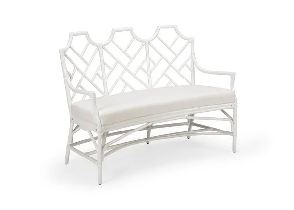 White rattan curved bench with geometric lattice back and upholstered white seat cushion