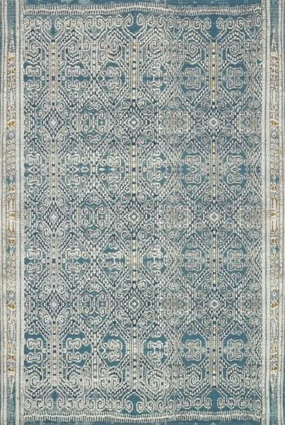 Mika Ocean Rug with blue and beige abstract tribal-inspired pattern, textured yarn, and blanket-stitch finish