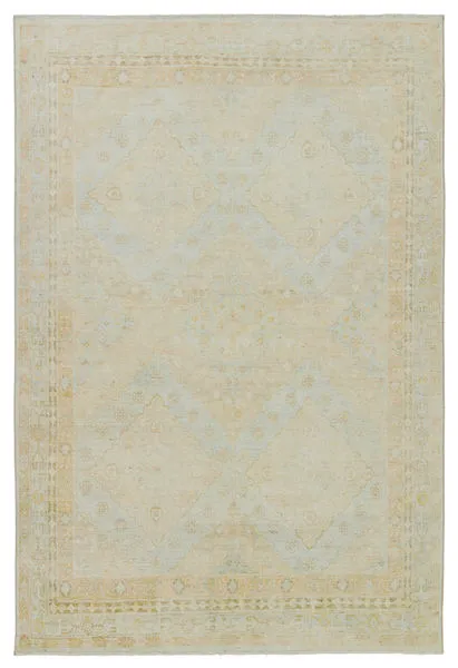 Winn Trellis rug with Persian-inspired diamond pattern and short fringe in light blue, pastel green, yellow, and cream