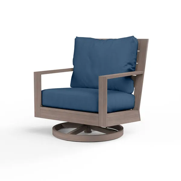 Laguna Swivel Club Rocker outdoor chair with driftwood-look aluminum frame and navy blue cushions