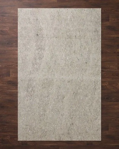 Beige rectangular 3/8 inch thick rug pad with soft textured surface on wood floor