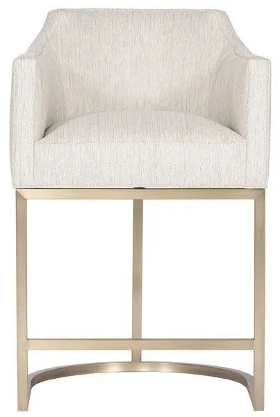 Ian Performance Metal Barrel Base Stool in brass with curved beige upholstered seat and armrests on a sleek metal barrel-s...