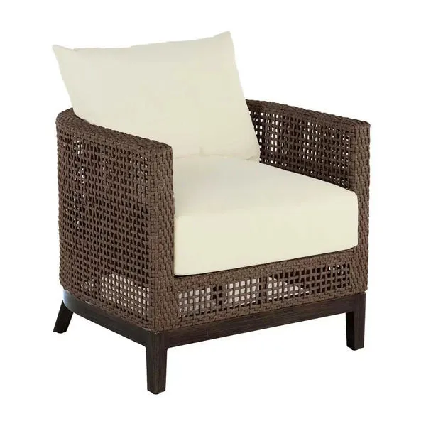 Outdoor barrel chair with dark brown woven raffia frame and cream seat and back cushions on wooden legs