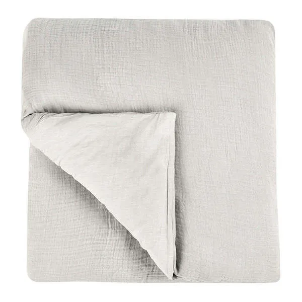 Gray linen duvet with a soft textured surface, folded corner showing lighter reverse side