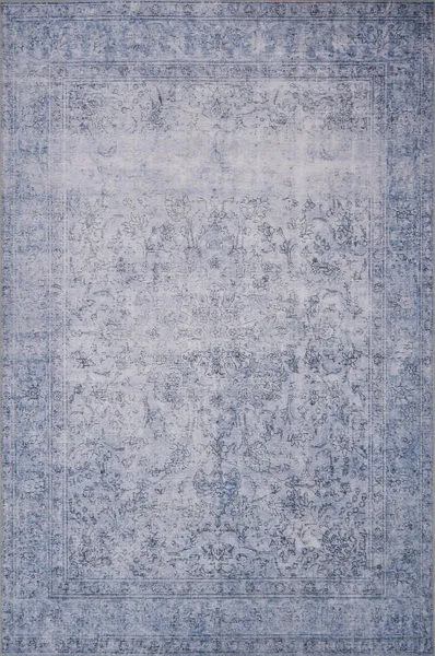 Loren Slate Rug with vintage-style faded blue floral and intricate border patterns on a soft polyester base
