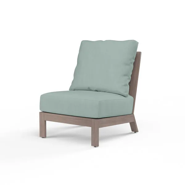 Laguna Armless Club outdoor accent chair with driftwood-look aluminum frame and light blue cushioned seat and back pillow