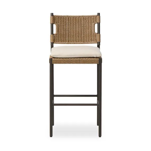 Outdoor bar stool with bronzed aluminum frame, all-weather woven wicker seat, and beige top cushion