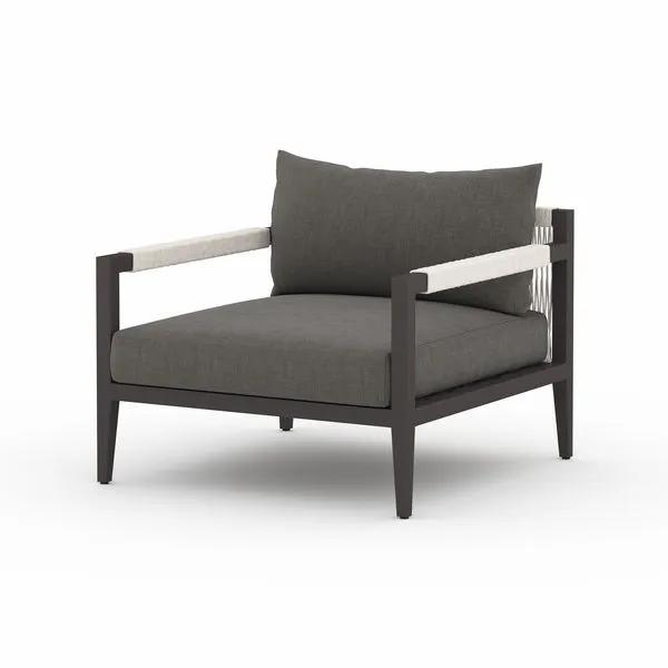 Sherwood Charcoal Outdoor Dark Wood Chair with dark cushions, rope-wrapped armrests, and cotton weaving on back