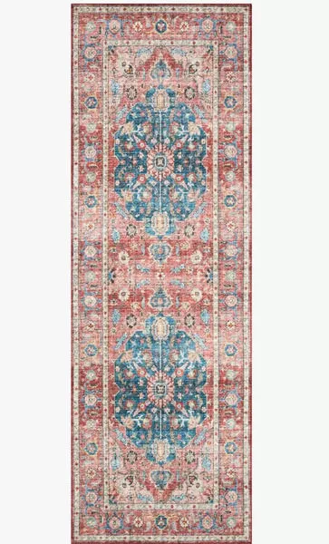 Long runner version of the rug showing a repeated medallion pattern in blue and coral shades
