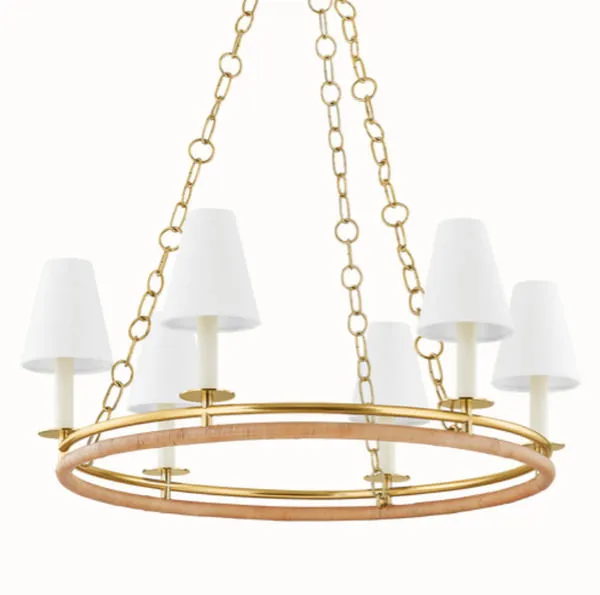 Frontal close-up of chandelier showing texture detail of wrapped rattan lower ring and smooth aged brass upper ring