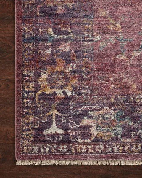 Close-up of Giada Grape / Multi Rug corner emphasizing textured pile and detailed floral border on wood floor