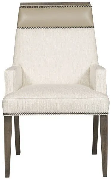 Dining arm chair upholstered in off-white Kidders Porcelain fabric with porcelain-colored leather trim and dark wood legs