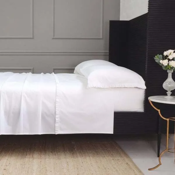 White Audrey Ruffle Cotton Percale Sheet Set on California King bed with ruffled edges and smooth cotton percale fabric