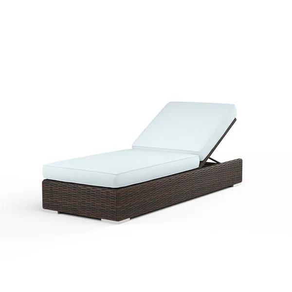 Montecito Adjustable Chaise with Cognac multi-colored resin wicker and white cushioned seat, backrest angled for reclining