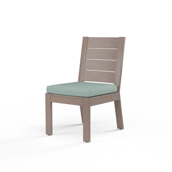 Laguna Armless Dining Chair in driftwood-like aluminum frame with horizontal slats and light teal cushion