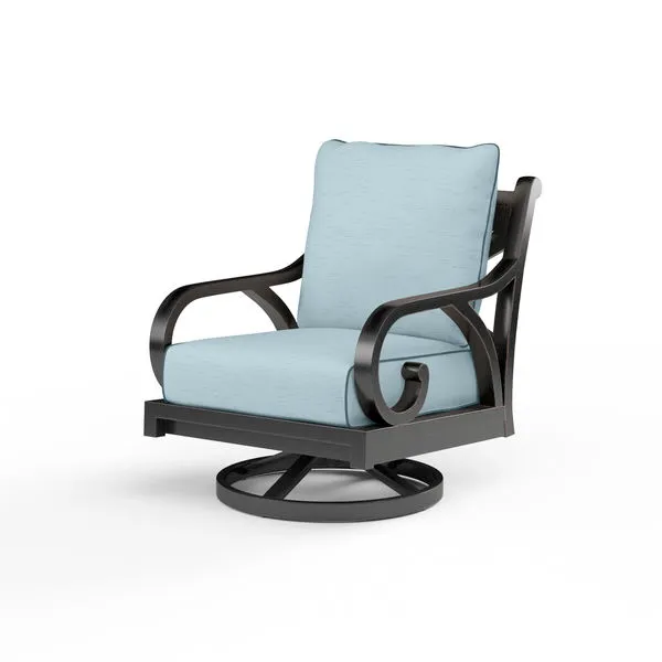 Outdoor swivel rocker chair with curved arms, cross back in dark metal frame and light blue cushioned seat and back