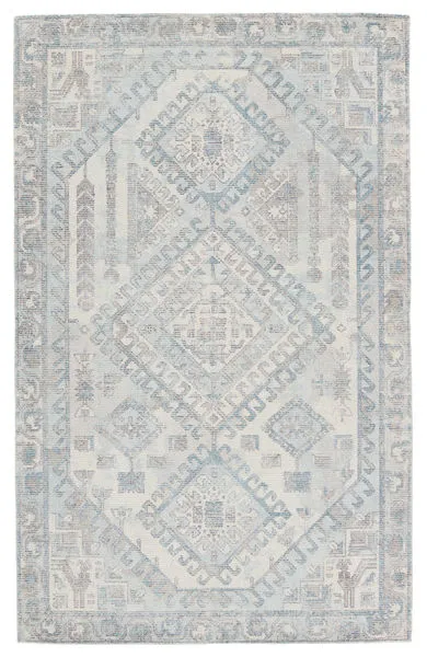 Light blue and gray handwoven rug with geometric medallion pattern and tribal-inspired details