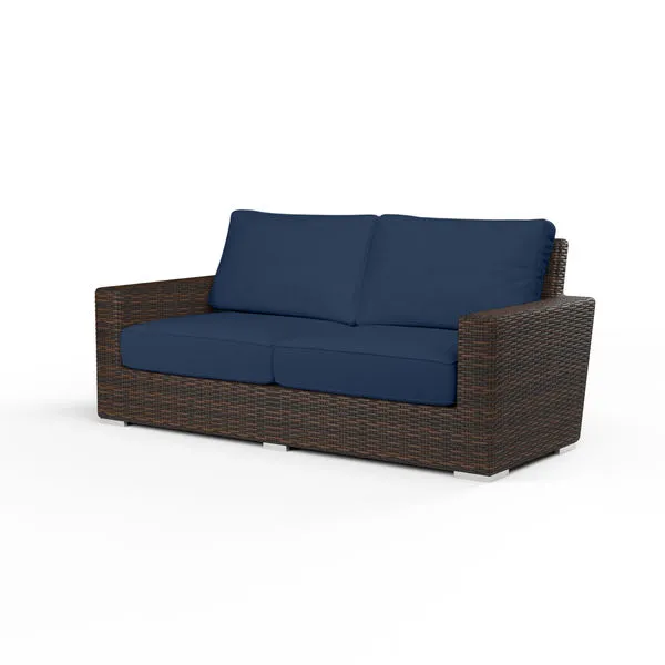 Montecito Loveseat outdoor sofa with cognac resin wicker frame and navy blue cushions