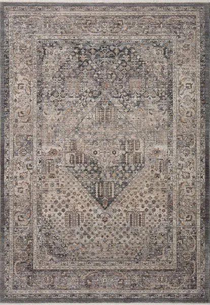 Traditional power-loomed Lyra Denim Pebble rug with watercolor-inspired soft blue and beige tones and intricate central me...