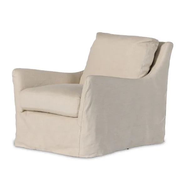Natural linen slipcover swivel chair with sloping flared arms and loose back cushion