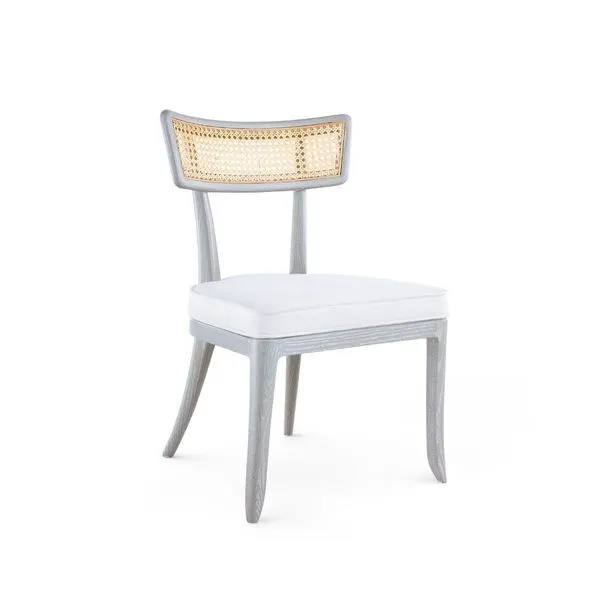 Dining chair with curved solid wood frame, bleached octagonal cane backrest, and natural linen seat cushion in sand