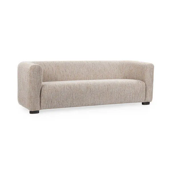 Soft beige fabric sofa with low backrest, rounded arms, and thick cushioned seat on black block feet