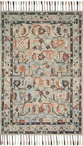 Transitional wool rug with whimsical floral motifs in muted blue, orange, and cream, featuring braided tassels on ends