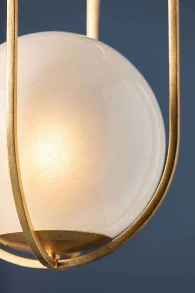 Verbank pendant light with vintage gold leaf cage encasing a softly glowing cloud glass orb
