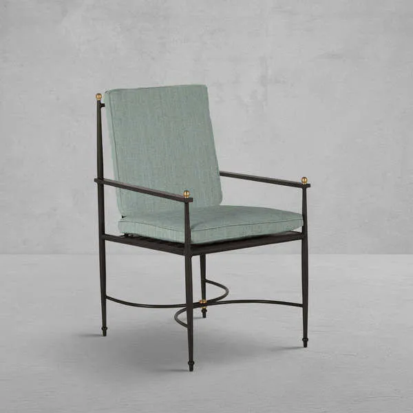 Outdoor Roma wrought aluminum arm chair with sleek black frame, gold accents, and muted green cushions