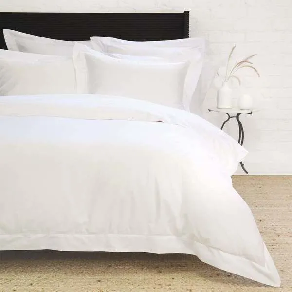 White Classico Hemstitch Cotton Sateen Euro Sham on a bed with hemstitch border and smooth sateen finish