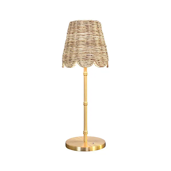 Table lamp with woven rattan scalloped shade and brass base with slim stem