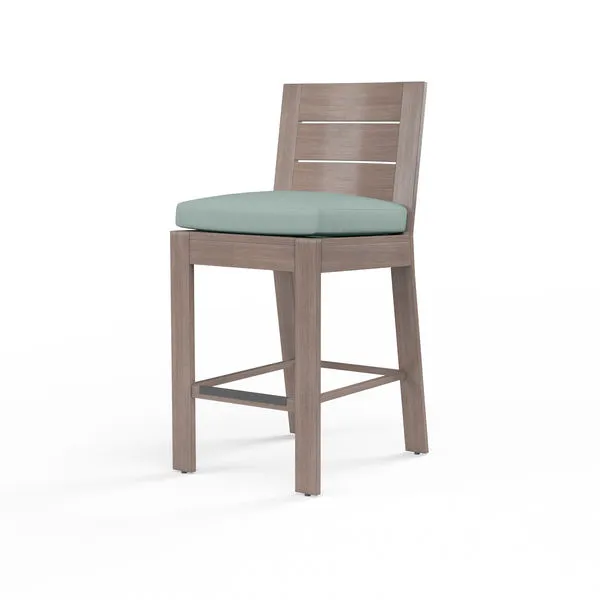 Laguna counter stool with aluminum frame and hand-brushed driftwood finish, pale blue padded seat cushion