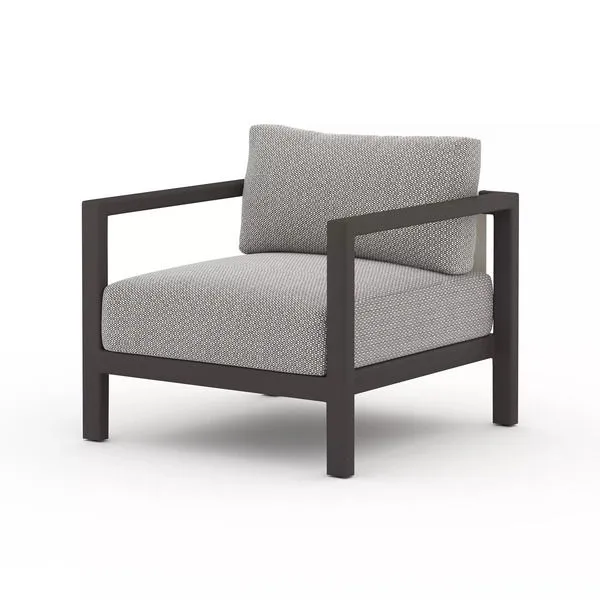 Sonoma Faye Ash Outdoor Chair with wide dark aluminum frame and neutral textured cushions