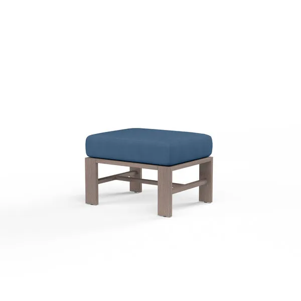 Laguna Ottoman with square driftwood-look aluminum frame and thick blue outdoor cushion