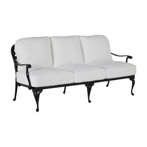 Outdoor sofa with white cushions and black aluminum frame featuring curved arms and decorative legs