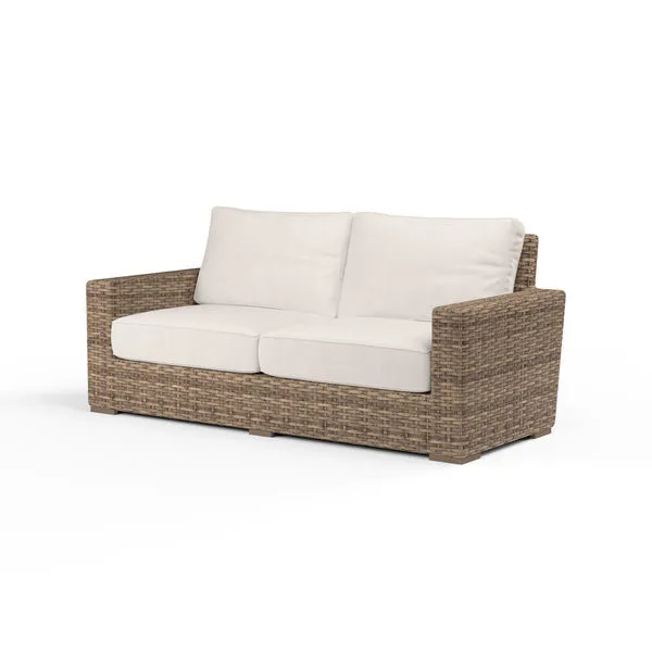 Havana Loveseat outdoor sofa with all-weather aged tobacco wicker frame and cream cushioned seating