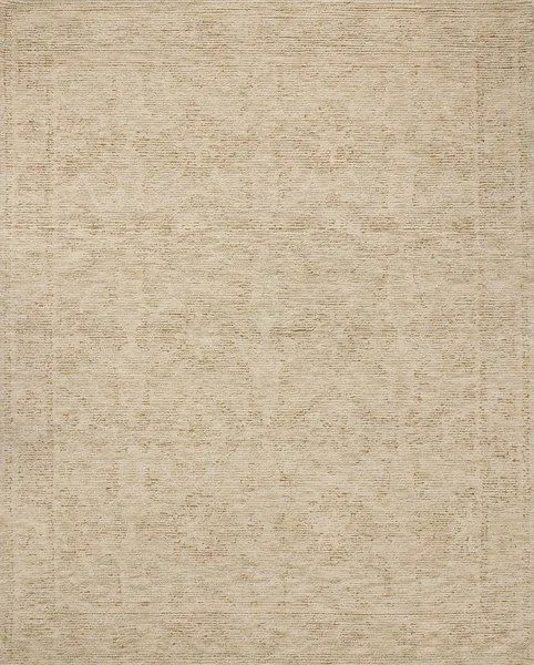 Natural wool area rug with ribbed high-low pile showing subtle traditional motifs in beige tones